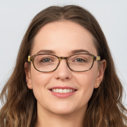 Joyful white young-adult female with long  brown hair and blue eyes