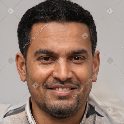 Joyful latino adult male with short  black hair and brown eyes