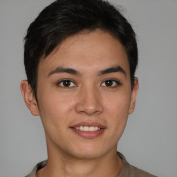 Joyful asian young-adult male with short  brown hair and brown eyes