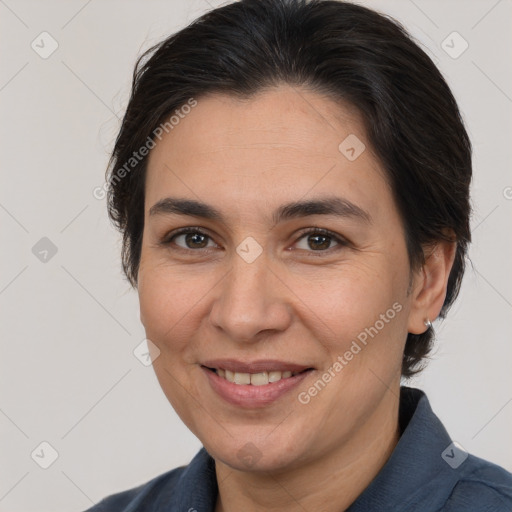 Joyful white adult female with medium  brown hair and brown eyes