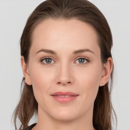 Joyful white young-adult female with long  brown hair and grey eyes