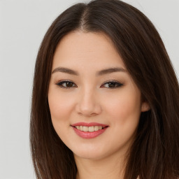 Joyful asian young-adult female with long  brown hair and brown eyes