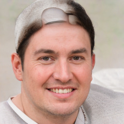 Joyful white adult male with short  brown hair and grey eyes