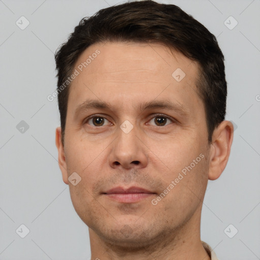 Joyful white adult male with short  brown hair and brown eyes