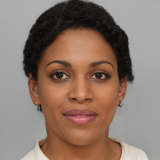 Joyful black young-adult female with short  brown hair and brown eyes