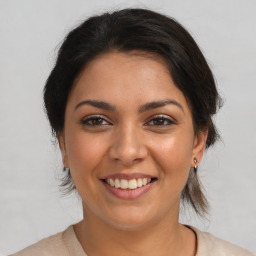 Joyful white young-adult female with medium  brown hair and brown eyes