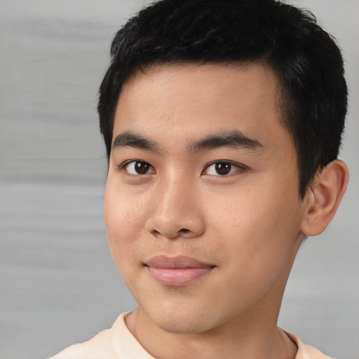 Joyful asian young-adult male with short  black hair and brown eyes