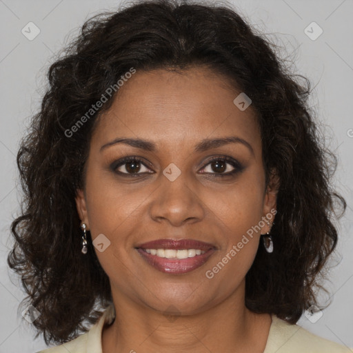 Joyful black adult female with long  brown hair and brown eyes