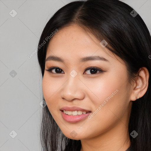 Joyful asian young-adult female with long  brown hair and brown eyes