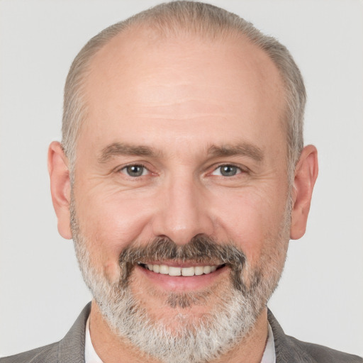 Joyful white middle-aged male with short  gray hair and brown eyes