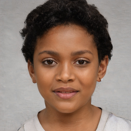 Joyful black child female with short  black hair and brown eyes