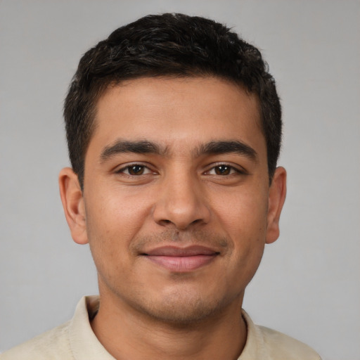 Joyful latino young-adult male with short  brown hair and brown eyes