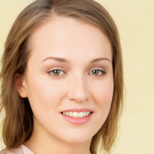 Joyful white young-adult female with long  brown hair and green eyes