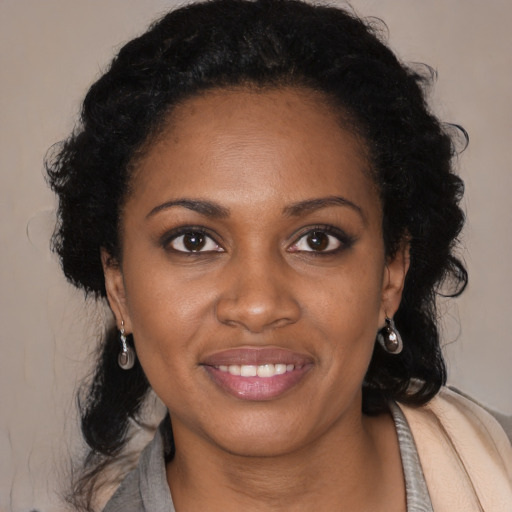 Joyful black young-adult female with medium  black hair and brown eyes