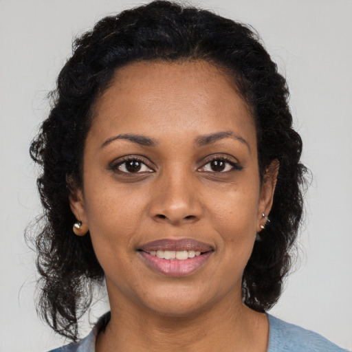 Joyful black young-adult female with medium  brown hair and brown eyes