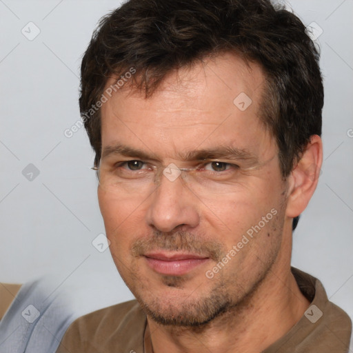 Joyful white adult male with short  brown hair and brown eyes