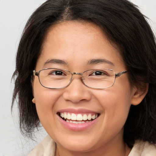 Joyful white adult female with medium  brown hair and brown eyes