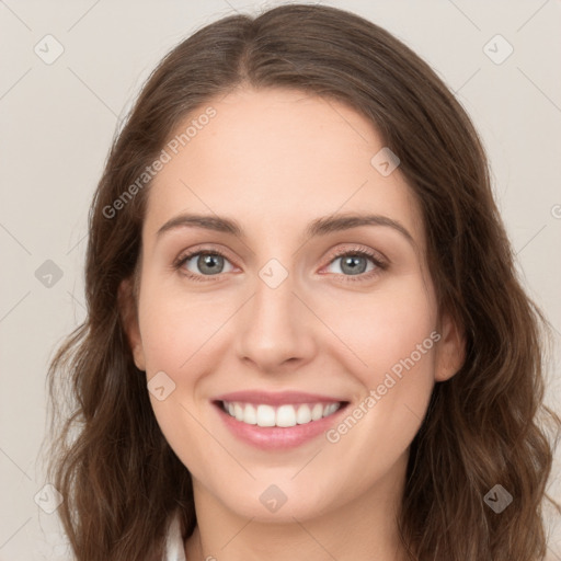 Joyful white young-adult female with long  brown hair and green eyes