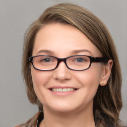 Joyful white young-adult female with medium  brown hair and blue eyes