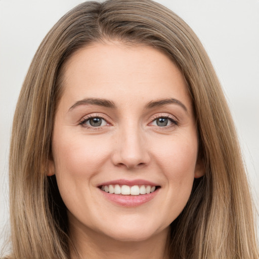 Joyful white young-adult female with long  brown hair and brown eyes