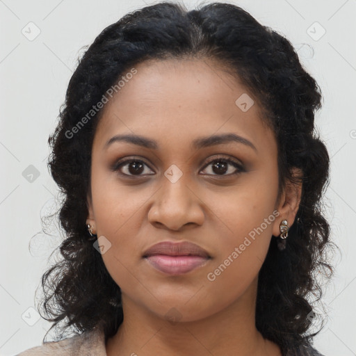 Joyful black young-adult female with long  brown hair and brown eyes