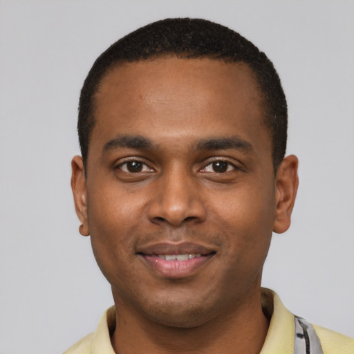 Joyful black young-adult male with short  black hair and brown eyes