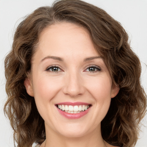 Joyful white young-adult female with medium  brown hair and green eyes