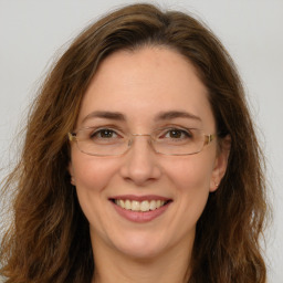 Joyful white adult female with long  brown hair and brown eyes