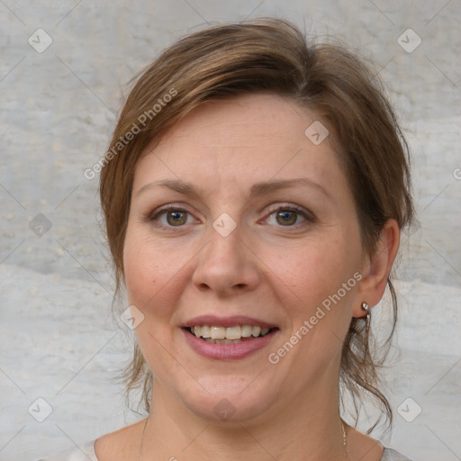 Joyful white adult female with medium  brown hair and blue eyes