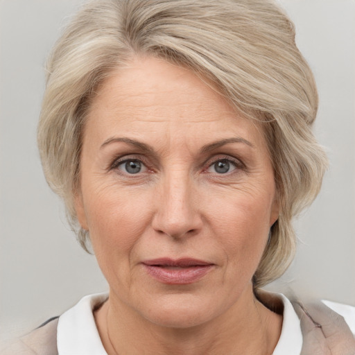 Joyful white adult female with medium  blond hair and brown eyes