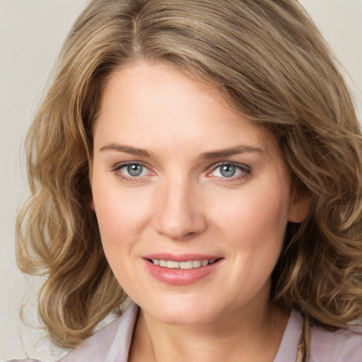 Joyful white young-adult female with medium  brown hair and green eyes