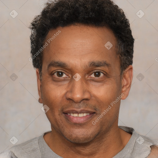 Joyful black adult male with short  brown hair and brown eyes