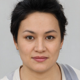 Joyful asian young-adult female with short  brown hair and brown eyes