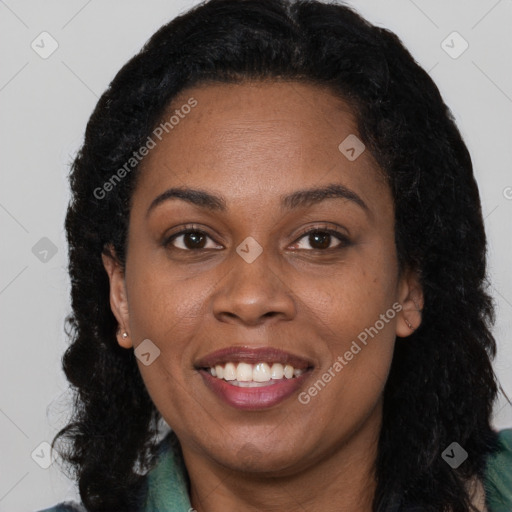 Joyful black adult female with long  brown hair and brown eyes