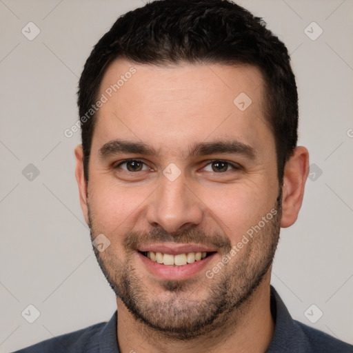 Joyful white young-adult male with short  black hair and brown eyes