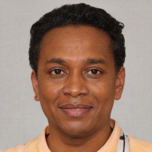 Joyful latino adult male with short  black hair and brown eyes