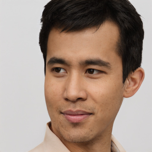 Joyful asian young-adult male with short  black hair and brown eyes