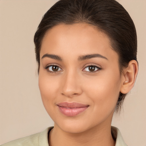 Joyful latino young-adult female with medium  brown hair and brown eyes