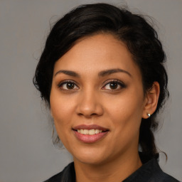 Joyful latino young-adult female with medium  black hair and brown eyes