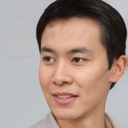 Joyful asian young-adult male with short  brown hair and brown eyes