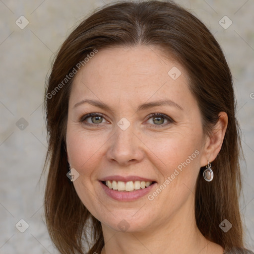 Joyful white adult female with long  brown hair and grey eyes