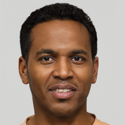 Joyful black young-adult male with short  black hair and brown eyes