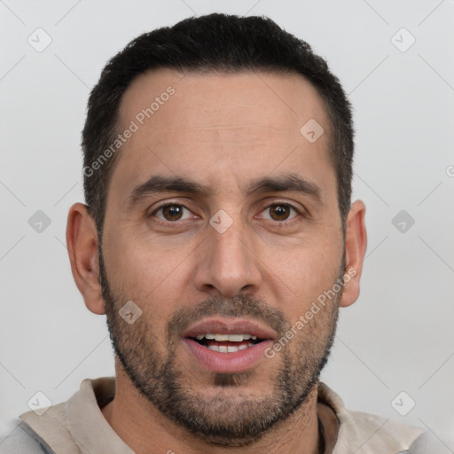 Joyful white adult male with short  black hair and brown eyes