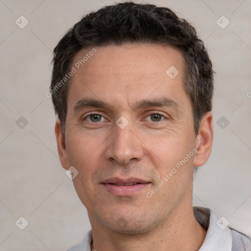 Joyful white adult male with short  black hair and brown eyes