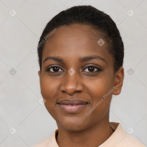 Joyful black young-adult female with short  black hair and brown eyes