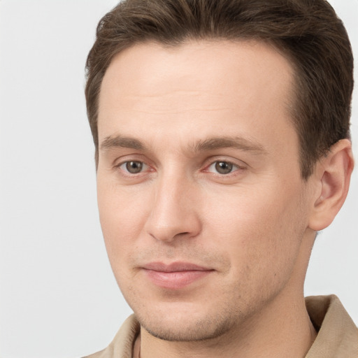 Joyful white young-adult male with short  brown hair and brown eyes