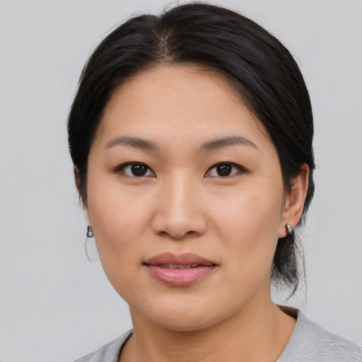 Joyful asian young-adult female with medium  brown hair and brown eyes