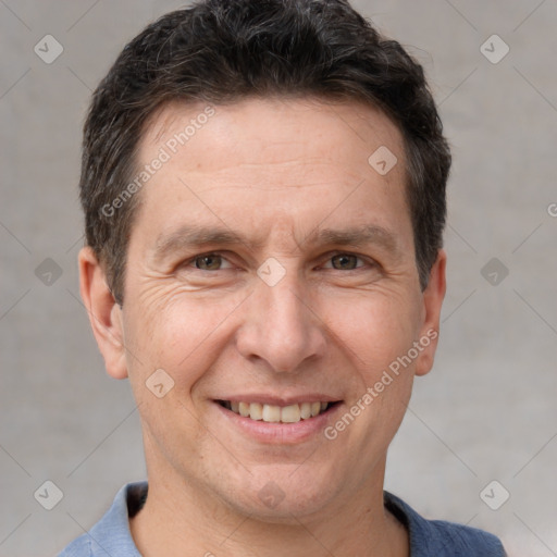 Joyful white adult male with short  brown hair and brown eyes