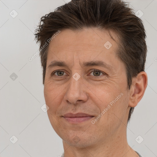 Joyful white adult male with short  brown hair and brown eyes