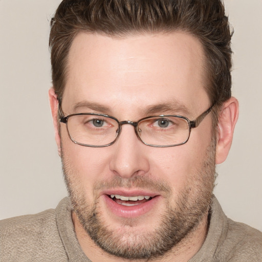 Joyful white adult male with short  brown hair and grey eyes